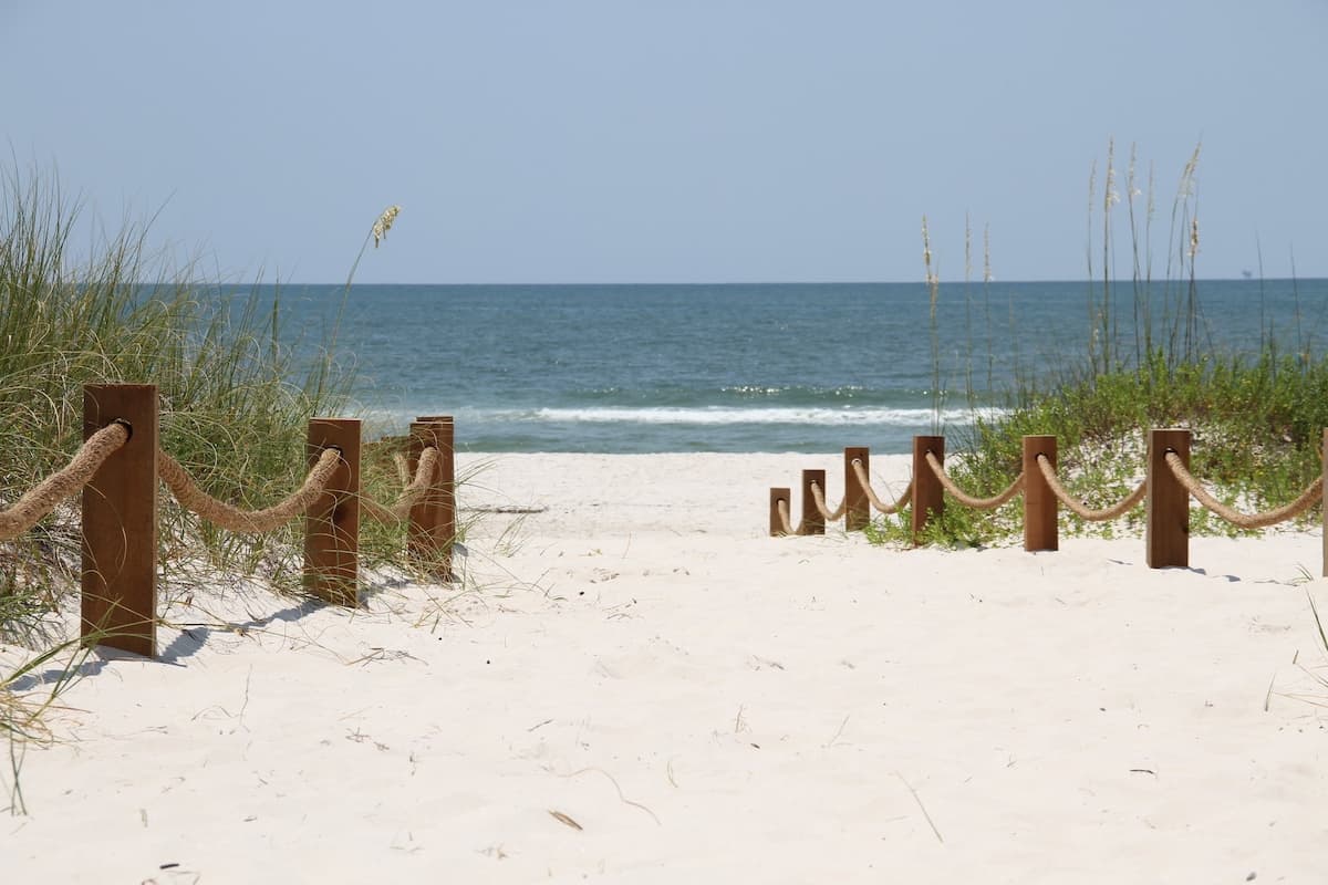 Wooden posts walkway down to the sandy beach 