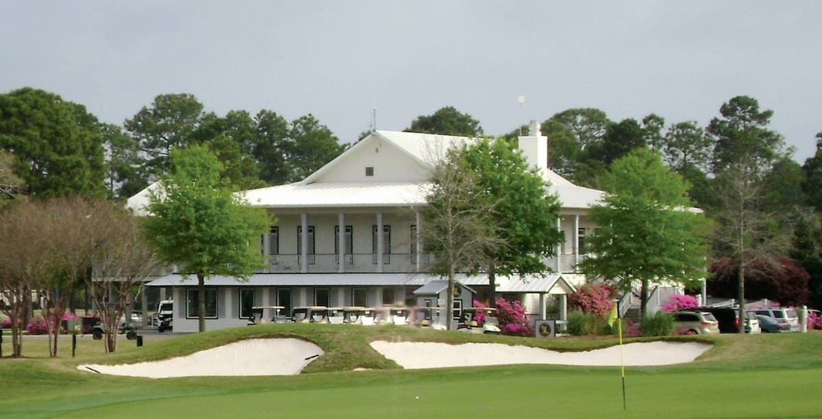 Large white club house at at Gulf Shores Golf Club where visitors can go relax after golfing